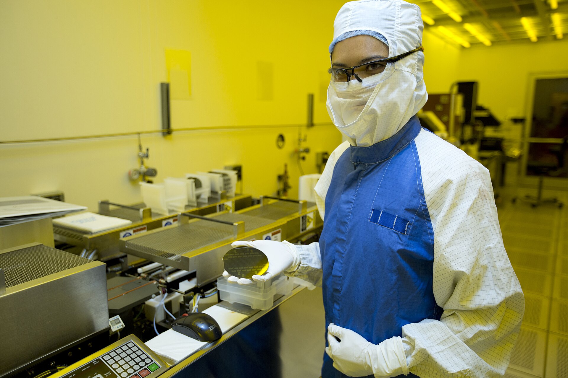 Researcher holding a silicon wafer used in semiconductor manufacturing